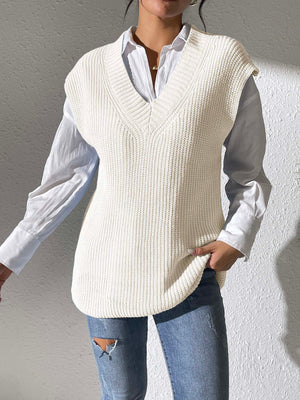 Ivory textured knit V-neck sleeveless top styled with a white shirt and jeans.