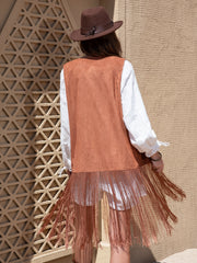Terracotta faux suede vest with fringe detail, worn over a white shirt.