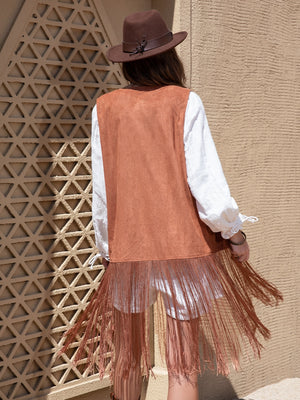Terracotta faux suede vest with fringe detail, worn over a white shirt.