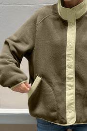 Moss fleece bomber jacket with contrast trim and snap closure.