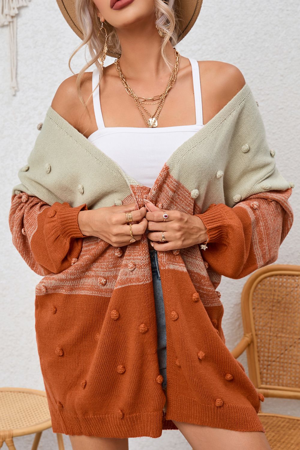 Textured colorblock bobble cardigan in pink and caramel acrylic with a relaxed fit.