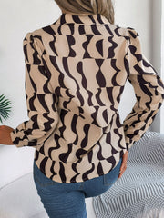 Tan abstract wave print silk-touch blouse with puff sleeves.