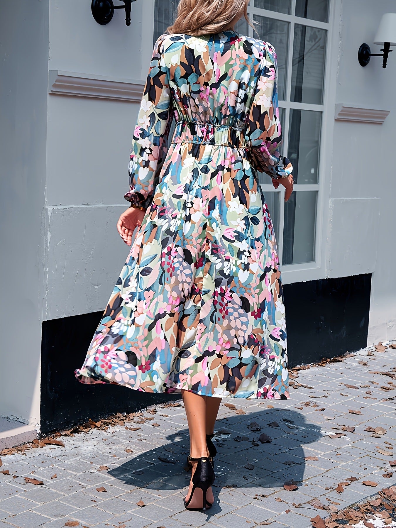 Floral print midi dress with V-neck, long sleeves, and tiered skirt in beige.