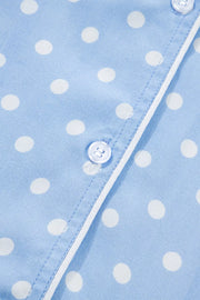 Blue polka dot viscose pajama top with white piping and button detail.