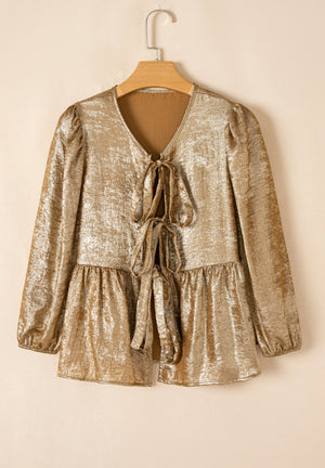 Gold peplum blouse with V-neck, tie front, and puff sleeves.