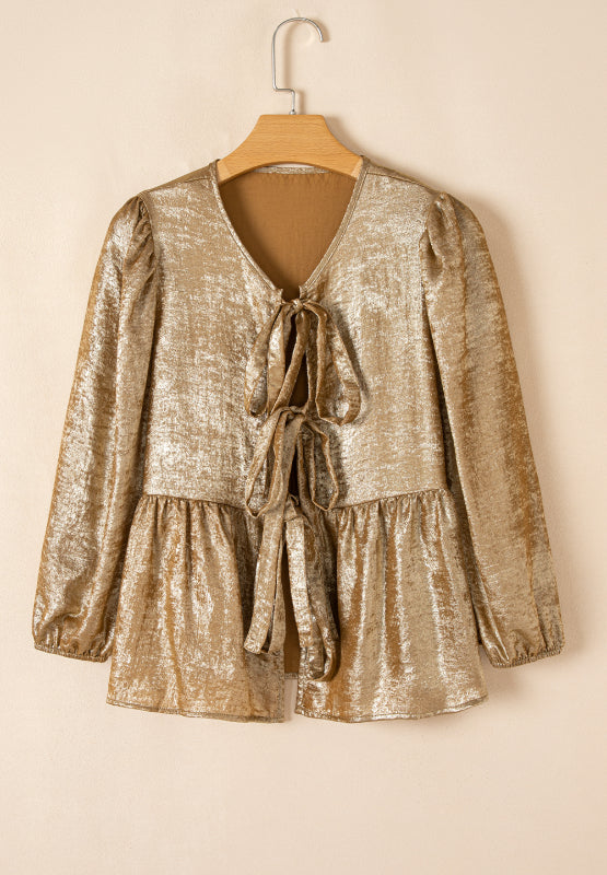 Gold peplum blouse with V-neck, tie front, and puff sleeves.