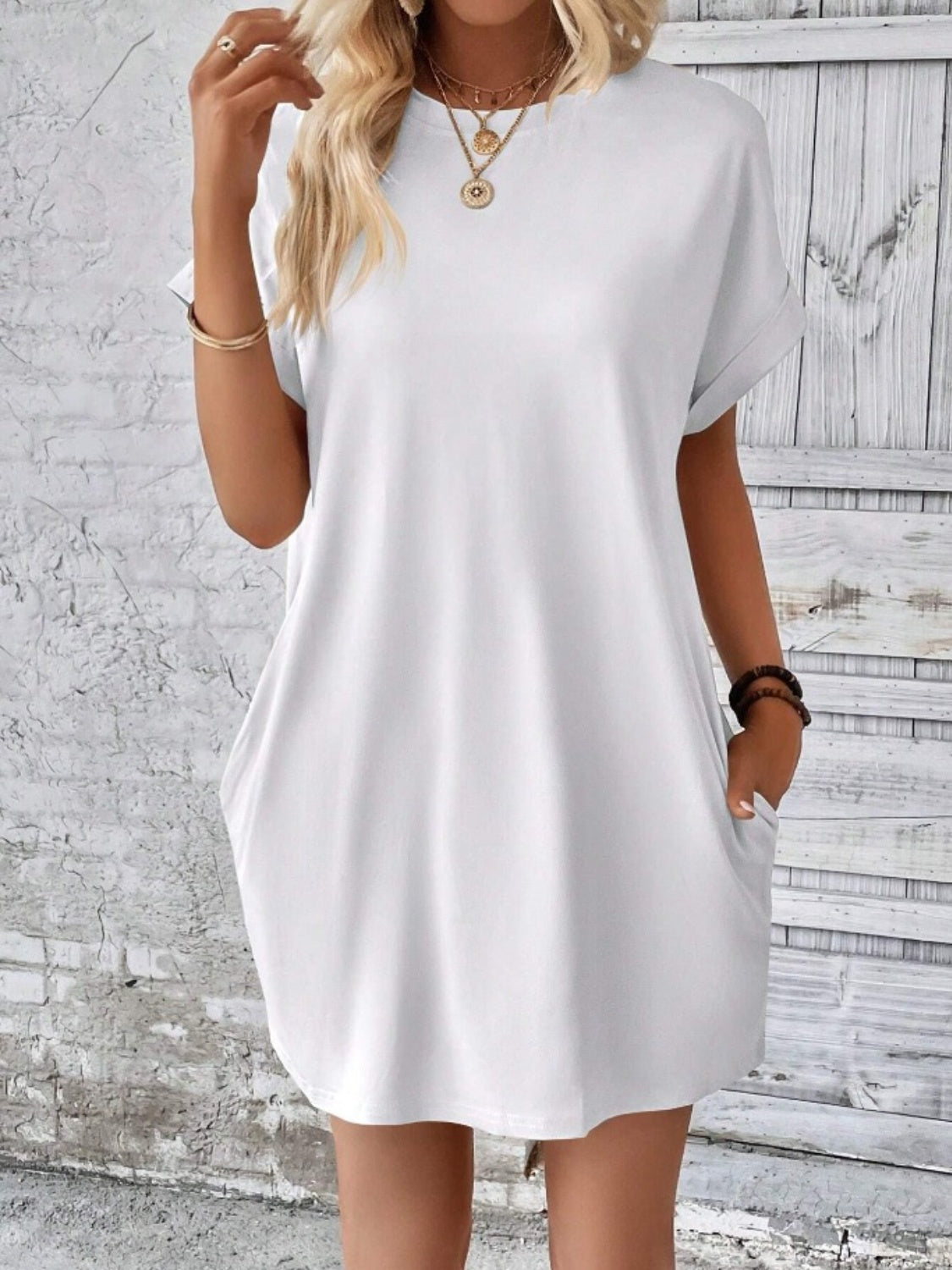 White relaxed tee dress with cuffed sleeves and pockets