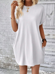 White relaxed tee dress with cuffed sleeves and pockets