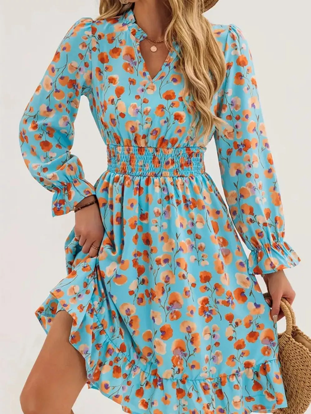 Pastel blue floral dress with smocked waist, ruffled cuffs and hem