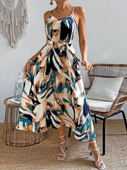Cami dress with abstract print, belted waist, and spaghetti straps.