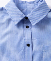 Light blue pinstripe button-down shirt with black buttons and a chest pocket.