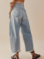 Light wash denim palazzo jeans with frayed hemline and wide leg.
