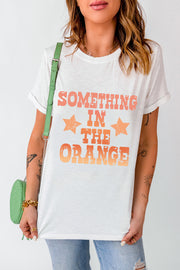 White graphic tee with faded orange text and stars, crew neck, short sleeves.
