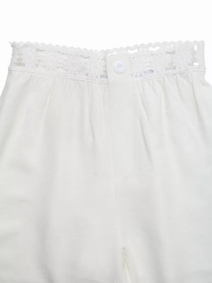 White wide-leg pants with crochet waistband detail and button closure.