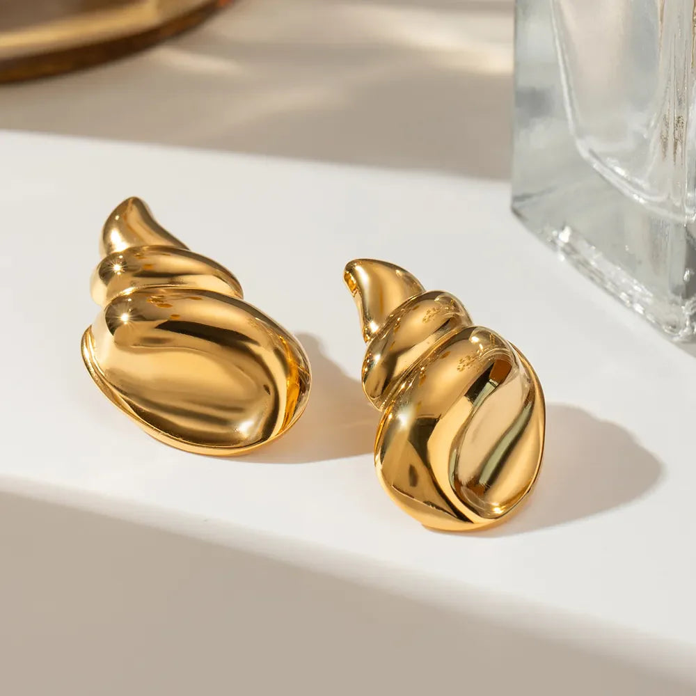 Gold sculptural seashell drop earrings with a polished finish.