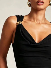 Black cowl neck tank top with draped fabric and gold ring strap details.