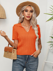 Orange cable knit polo top with short sleeves and a collared neckline.