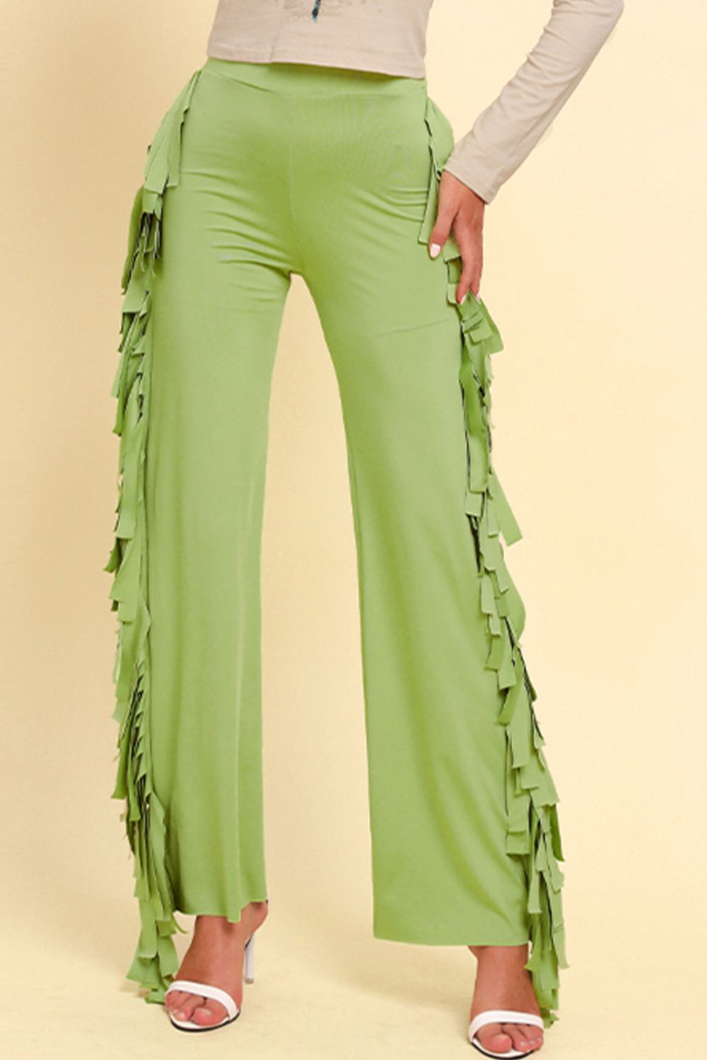 Yellow-green palazzo trousers with cascading fringe detail on the sides.