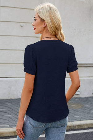 Dark navy textured V-neck blouse with short puff sleeves
