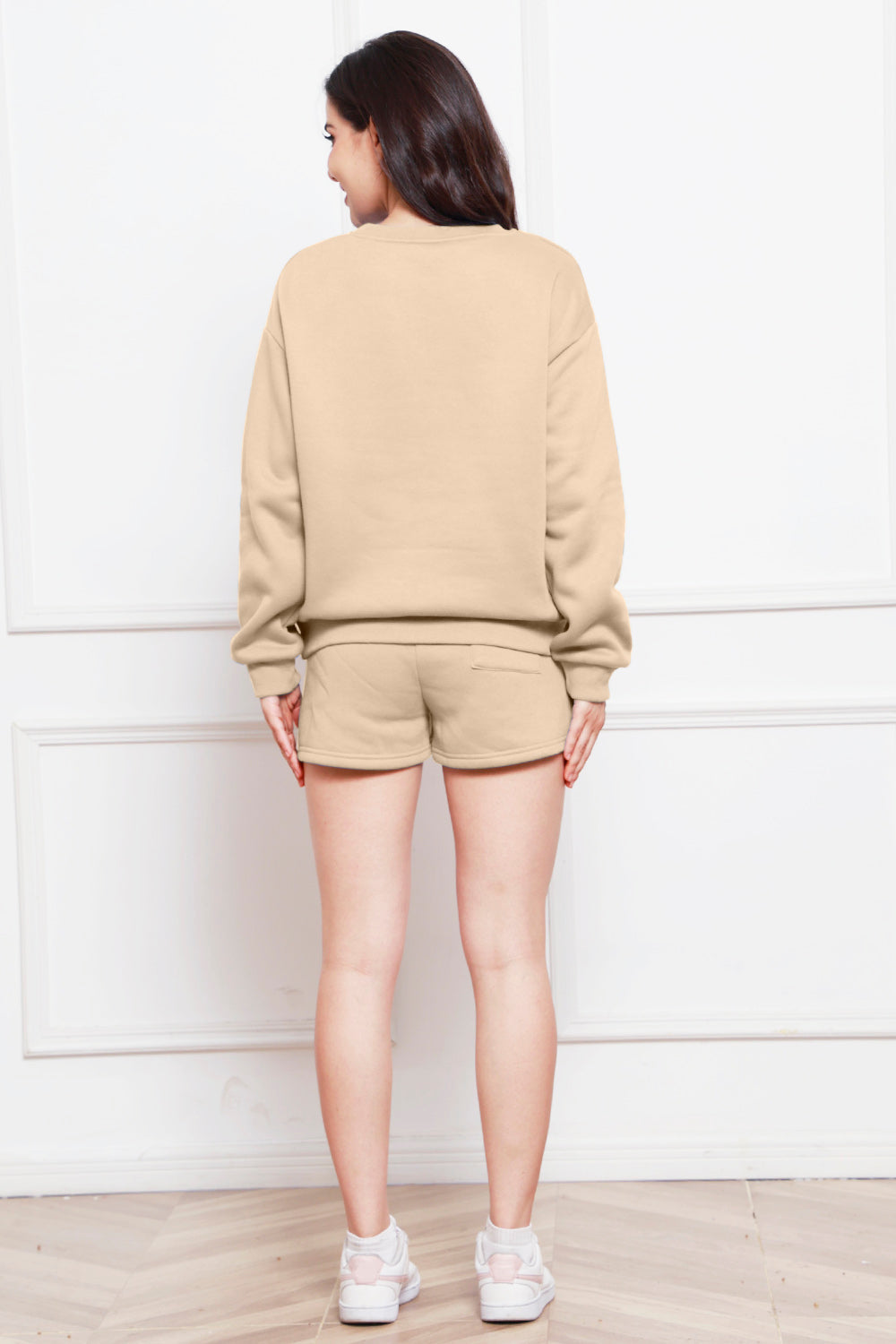 Beige crewneck loungewear set with pocket shorts.