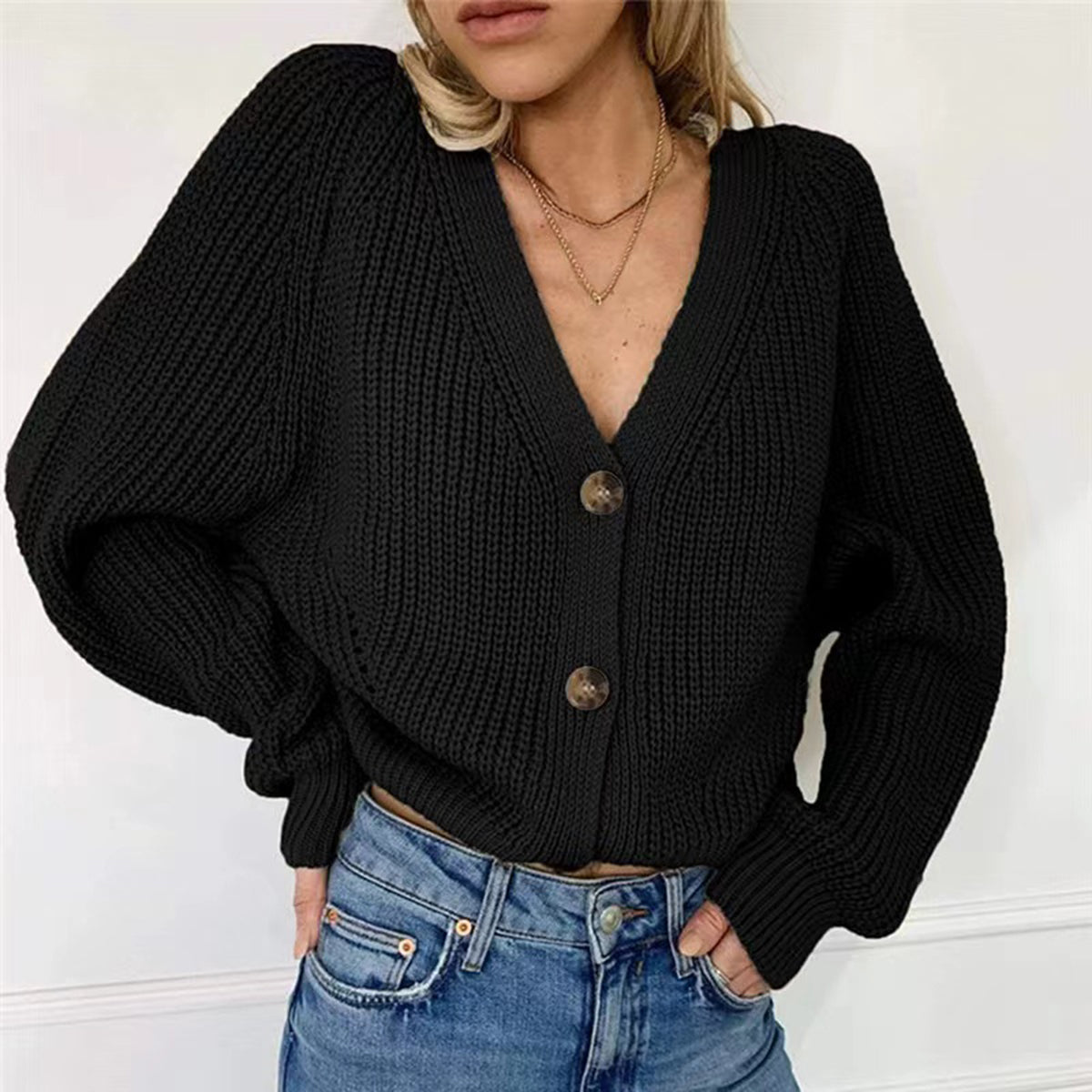 Black ribbed knit cardigan with balloon sleeves and button front.