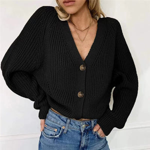 Black ribbed knit cardigan with balloon sleeves and button front.