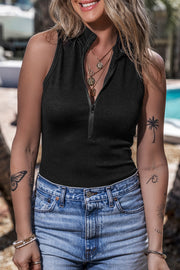 Black ribbed sleeveless bodysuit with zip-up mock neck, styled with denim shorts.