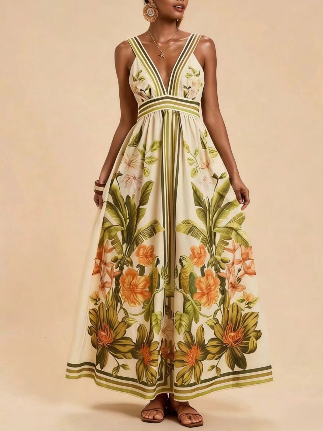 Tropical leaf print maxi dress with deep V-neck and striped straps.