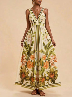 Tropical leaf print maxi dress with deep V-neck and striped straps.