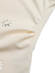 Cream cowl neck bodysuit with rhinestone embellishments and ruching detail.