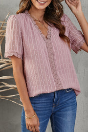 Dusty pink dotted swiss lace trim v-neck blouse with short puff sleeves.