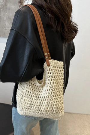 Ivory crochet weave shoulder bag with tan leather strap.