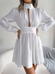White fit-and-flare mini dress with keyhole neckline, long sleeves, and gathered waist.