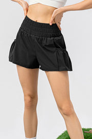 Black gathered waistline active shorts with ruffled pockets.