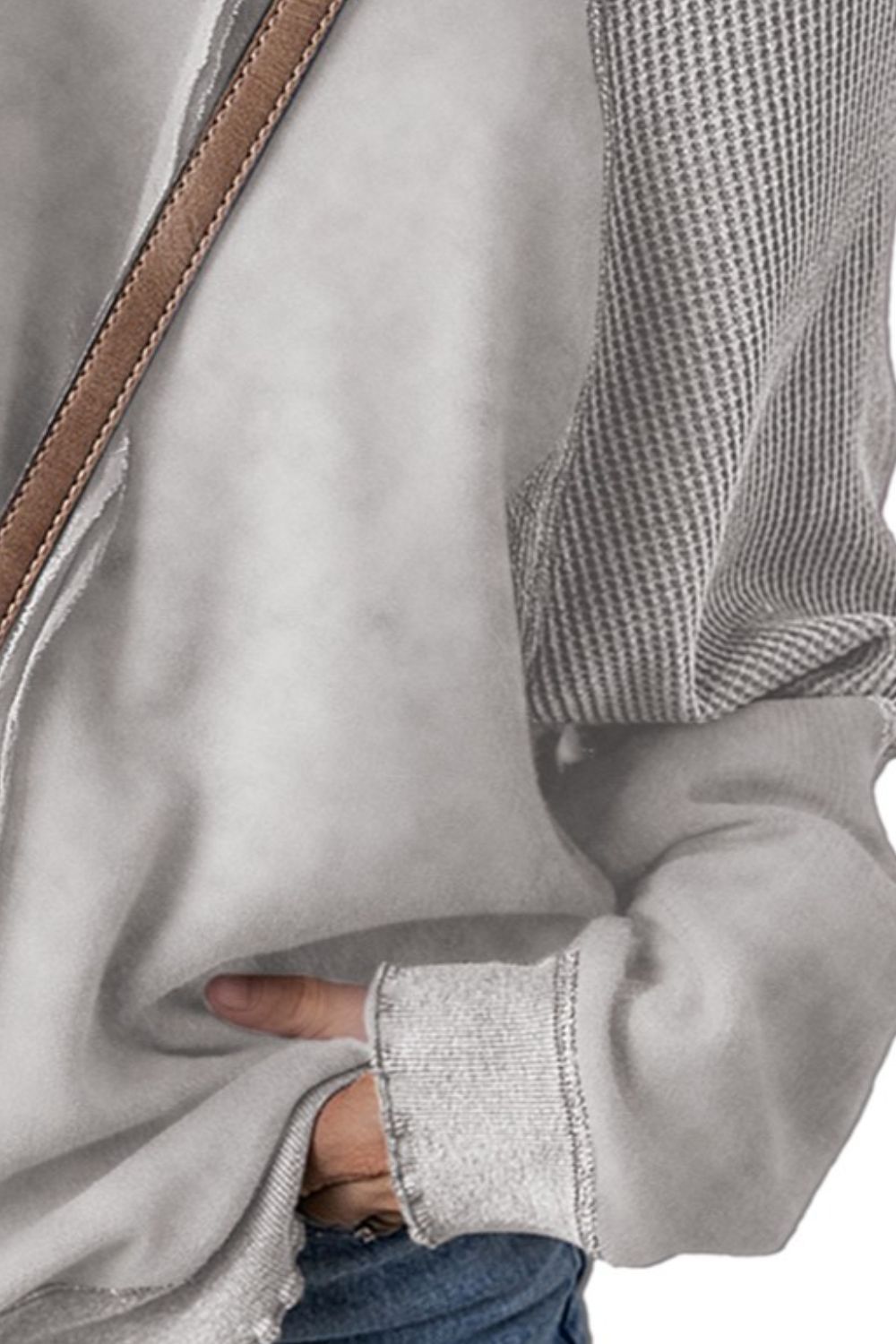 Gray waffle knit raglan sweatshirt with contrast striped sleeves and raw hem cuffs.