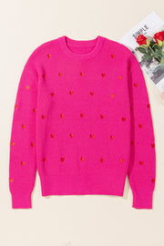 Pink ribbed crewneck sweater with all-over embroidered red hearts.