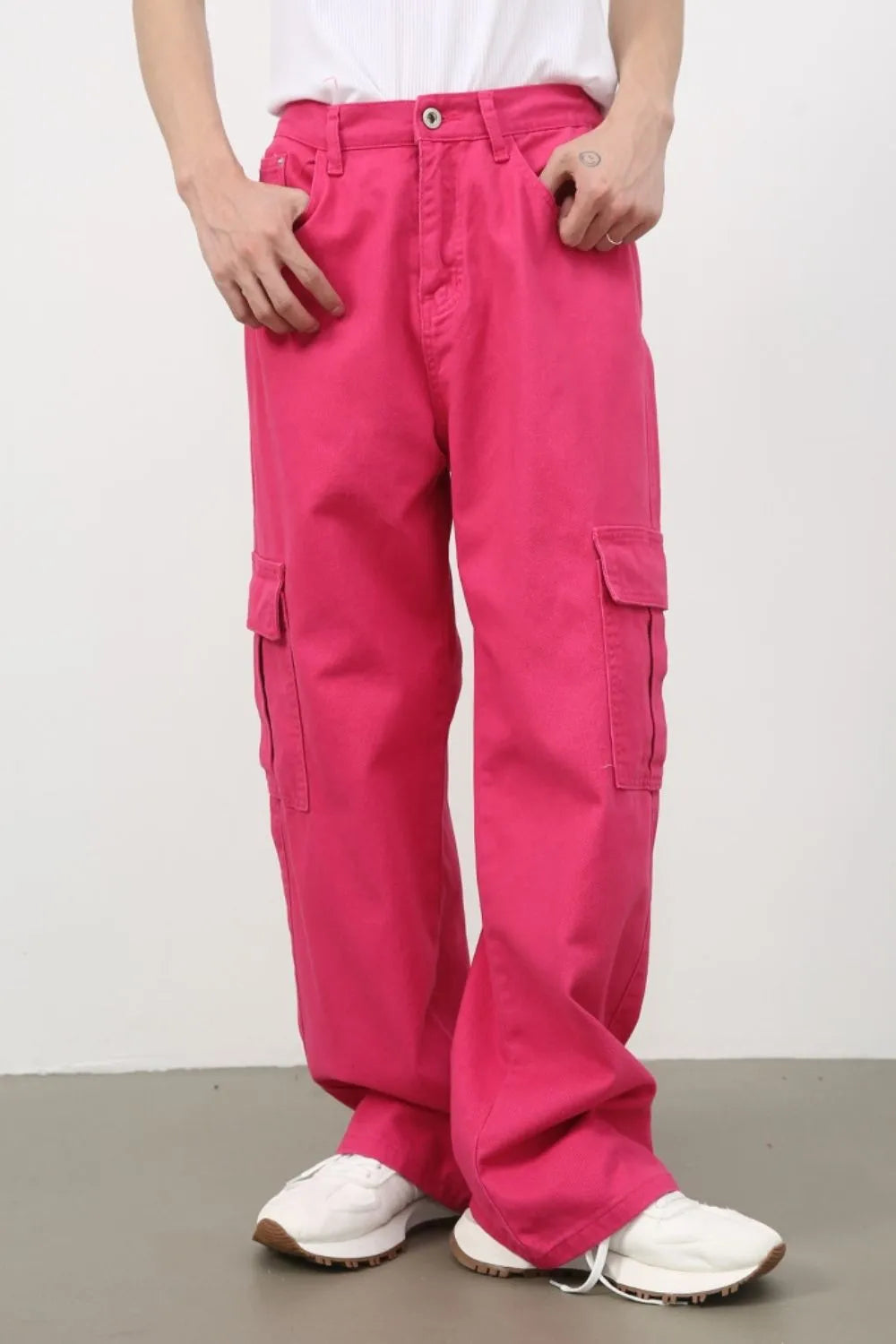 Electric pink baggy cargo pants with multiple pockets.