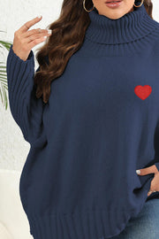 Navy turtleneck sweater with red heart appliqué and ribbed sleeves.