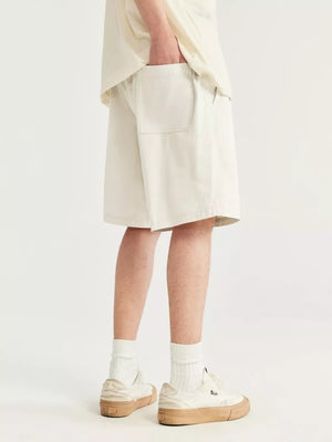 Men's ivory chino shorts with drawstring and back pocket detail.