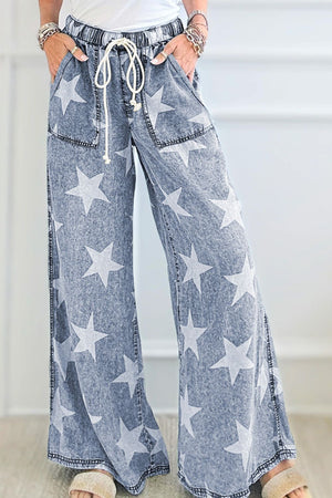 Cosmic Wash Star Print Palazzo Jeans in medium wash denim with a drawstring waist and wide leg