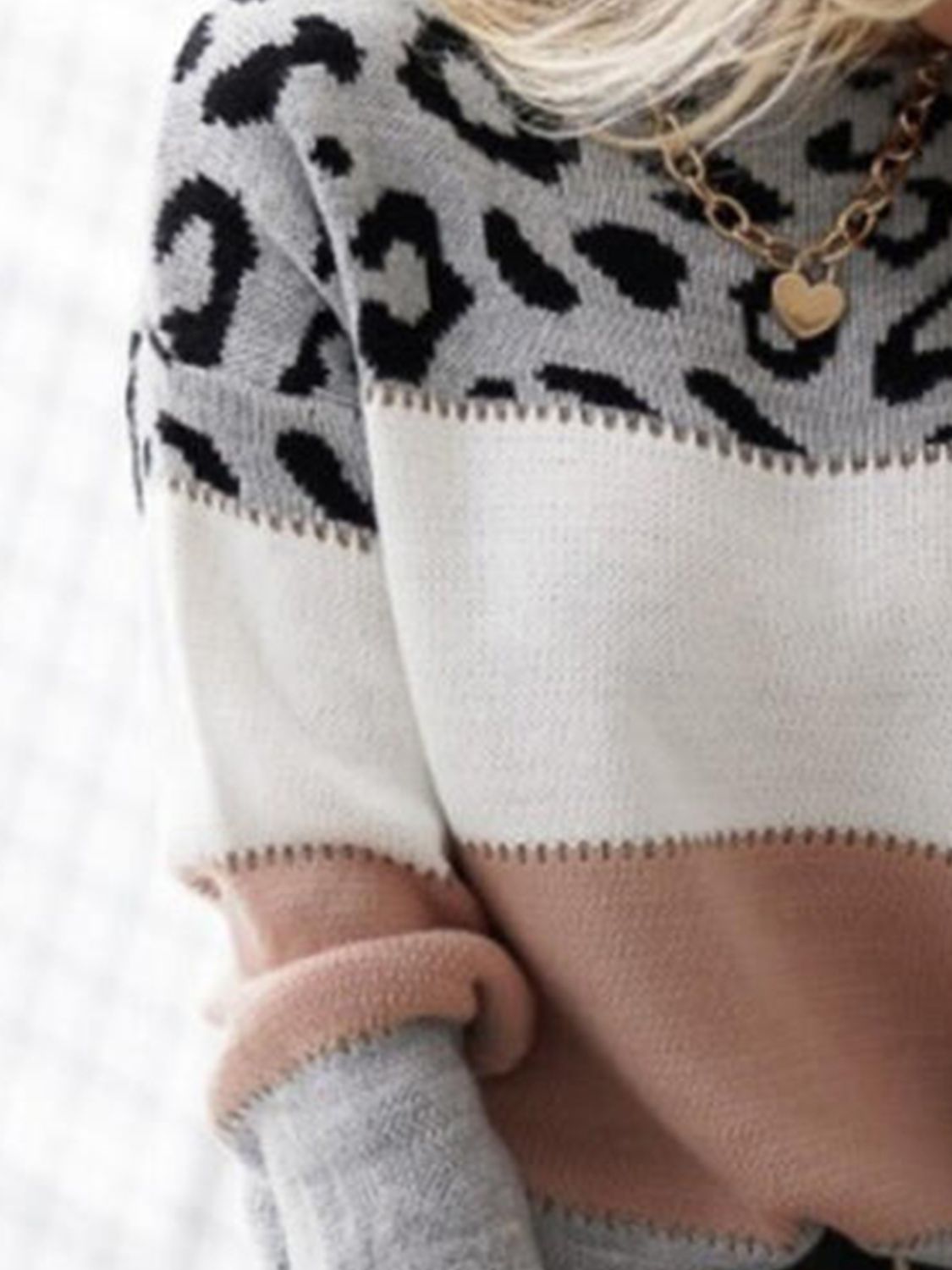 Leopard panel knit sweater with colorblock gray, white, and dusty pink sections.