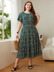 Emerald floral midi dress with tiered skirt and short sleeves.