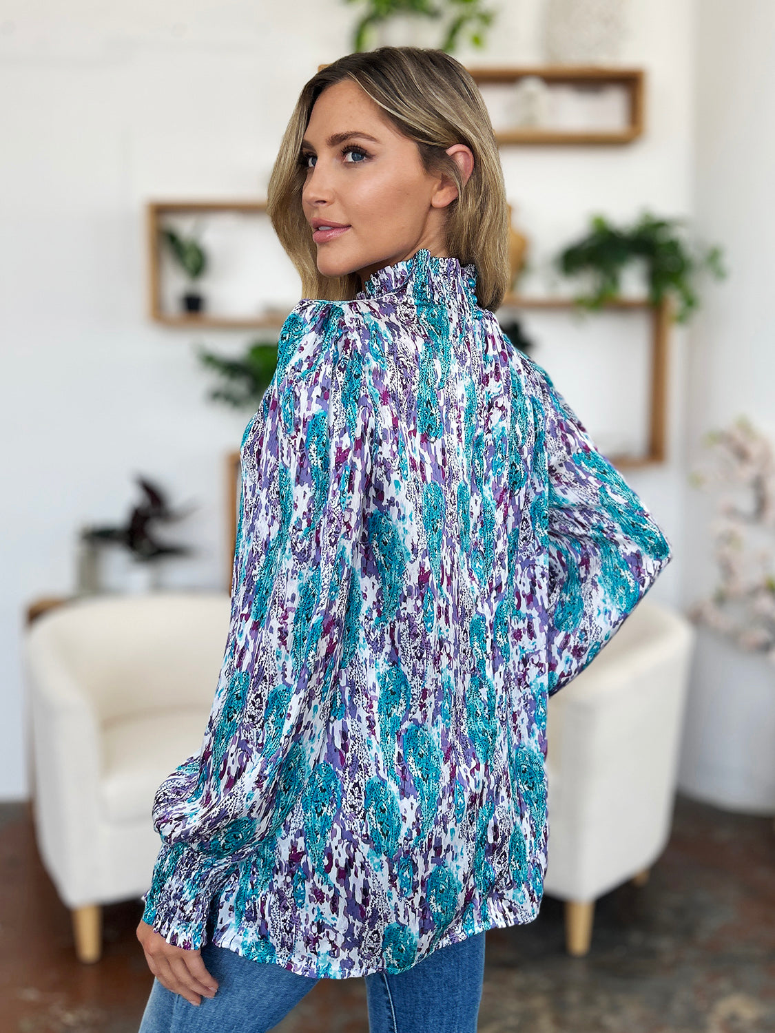 High neck abstract print blouse in blue and violet with long sleeves.
