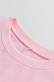 Dusty pink sweatshirt with ribbed crew neck and floral peace sign detail.