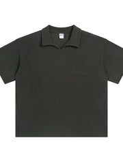 Boxy knit polo shirt in dark gray with a patch pocket and open collar.