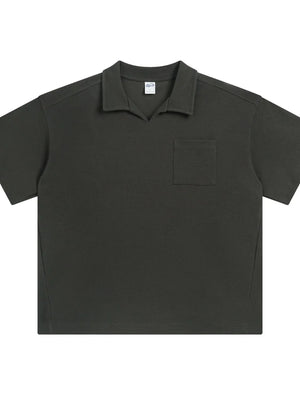 Boxy knit polo shirt in dark gray with a patch pocket and open collar.