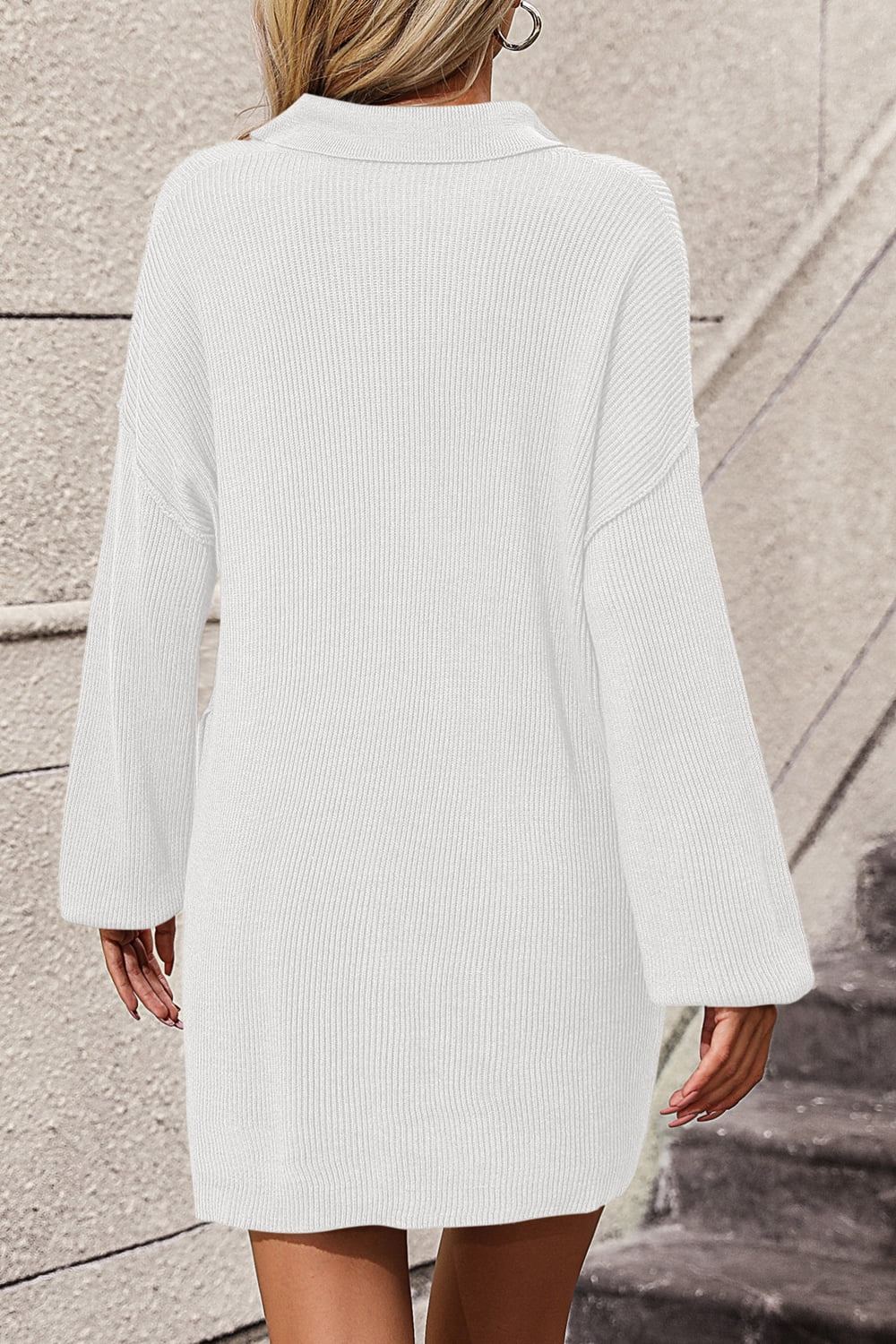 White collared knit tunic with pocket detail and bell sleeves.