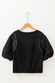Black blouse with contrast stitching, puff sleeves, and a crew neck.