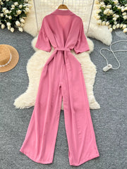 Pink belted wide-leg maternity jumpsuit with pockets and short sleeves