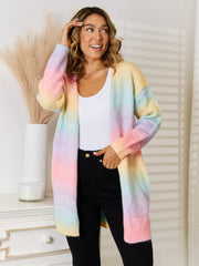 Rainbow gradient longline knit cardigan with pastel colors, open front, and long sleeves.